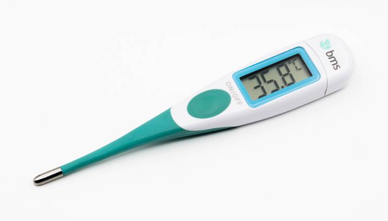 Thermomètre numérique affichant 35,8 degrés Celsius, posé sur un fond blanc.